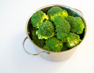 Fresh broccoli in casserole dish, isolated