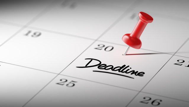 Concept image of a Calendar with a red push pin. Closeup shot of