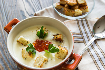 cheese soup puree with croutons and red caviar