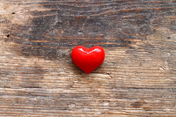Small red heart on wooden table