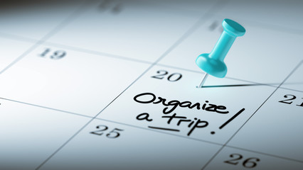 Concept image of a Calendar with a blue push pin. Closeup shot o
