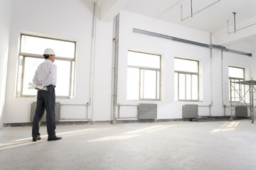 Fototapeta premium Pensive contractor on construction site