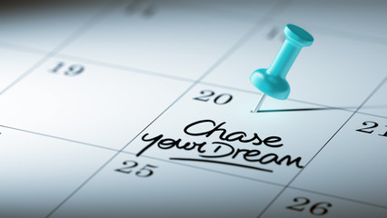 Fototapeta premium Concept image of a Calendar with a blue push pin. Closeup shot o
