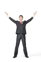 Young businessman with his arms extended