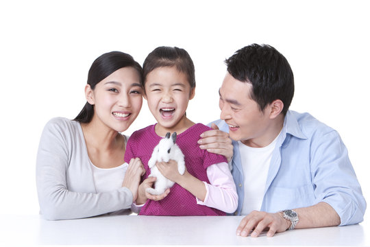 Family playing with rabbit