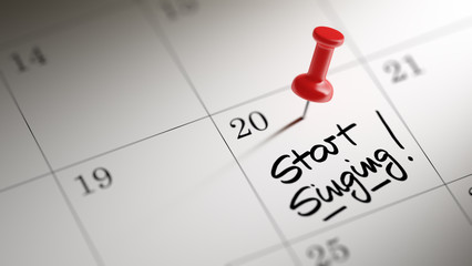 Concept image of a Calendar with a red push pin. Closeup shot of