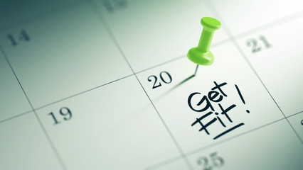 Concept image of a Calendar with a green push pin. Closeup shot