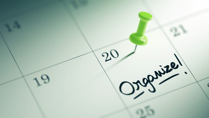 Concept image of a Calendar with a green push pin. Closeup shot