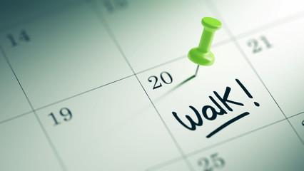 Concept image of a Calendar with a green push pin. Closeup shot