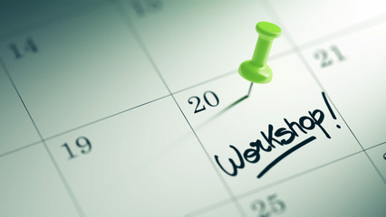 Concept image of a Calendar with a green push pin. Closeup shot