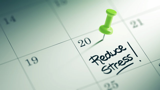 Concept image of a Calendar with a green push pin. Closeup shot