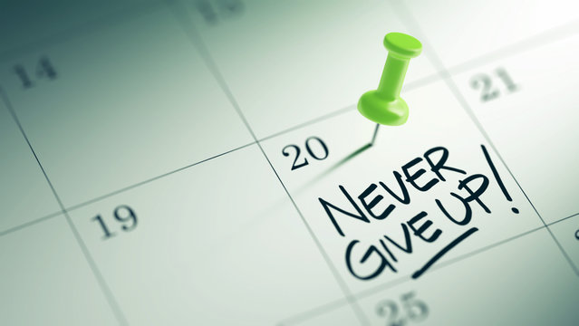 Concept image of a Calendar with a green push pin. Closeup shot