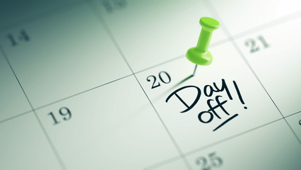 Concept image of a Calendar with a green push pin. Closeup shot