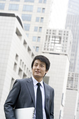 Fototapeta premium Businessman Holding Laptop