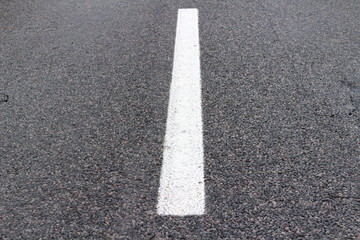 Obraz premium White stripe on the asphalt