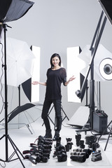 Photographer in studio with many cameras on the ground