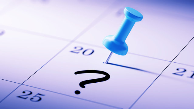 Concept image of a Calendar with a blue push pin. Closeup shot o