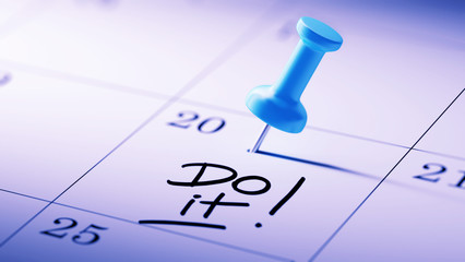 Concept image of a Calendar with a blue push pin. Closeup shot o