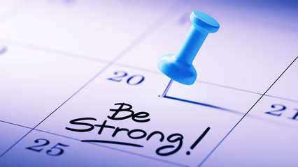 Concept image of a Calendar with a blue push pin. Closeup shot o