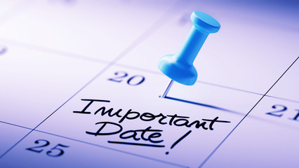Fototapeta premium Concept image of a Calendar with a blue push pin. Closeup shot o