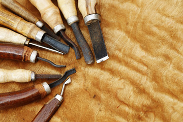 carving tool closeup on wooden background