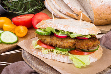 sandwich with fried meat and vegetables