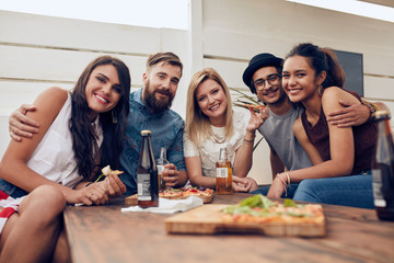 Friends gathered around the table at a roof party