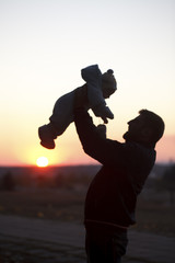 Dad and Child silhouette at sunset