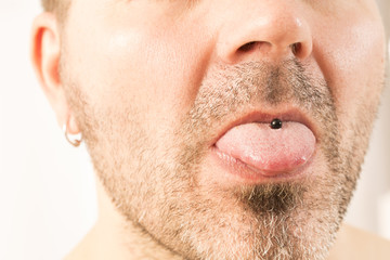 Man showing off his tongue ring