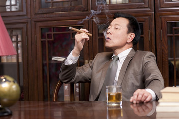 Successful businessman enjoying cigar