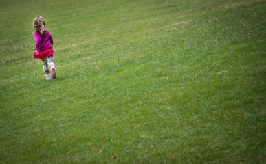 Fototapeta na wymiar Girl running on the grass