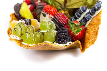 Variety of fresh fruits with decorative chocolate on white background 