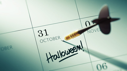 Concept image of a Calendar with a golden dart stick.. The words