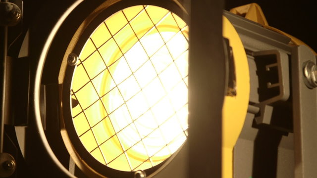 Video studio fresnel lens spot light with metal shutters close-up dolly shot 