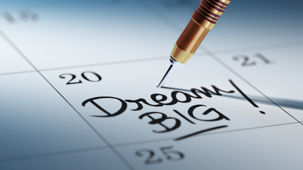 Concept image of a Calendar with a golden dart stick.. The words