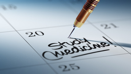 Concept image of a Calendar with a golden dart stick.. The words