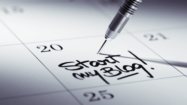 Concept image of a Calendar with a golden dart stick.. The words