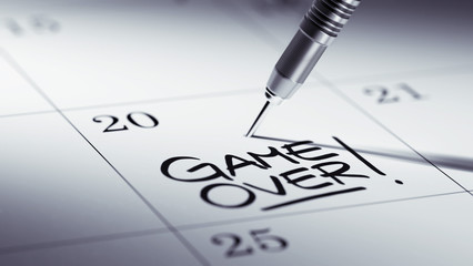 Concept image of a Calendar with a golden dart stick.. The words