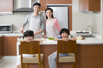Happy young family cooking in kitchen