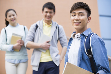 Young college students outside library