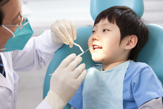 Little patient receiving treatment in dental clinic