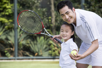 Father and daughter on the tennis court