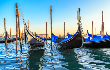 Gondolas moored by Saint Mark square with San Giorgio di Maggiore church in the background - Venice, Venezia, Italy, Europe