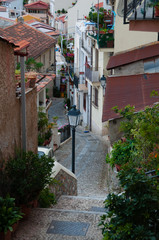 Fototapeta na wymiar Narrow street and stairs between cute italian houses in old town of Scilla