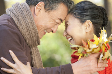 Senior couple smiling face to face in Autumn
