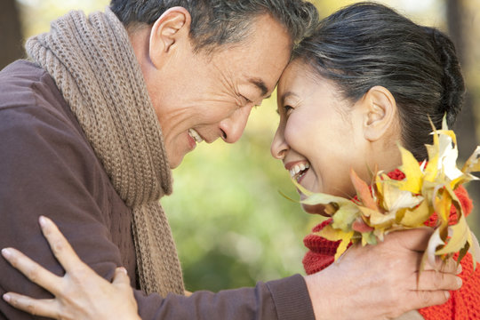 Senior couple smiling face to face in Autumn