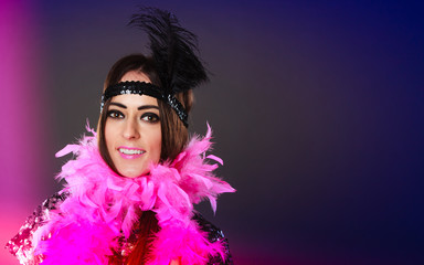 Girl pink plume and black feather on head. Carnival.