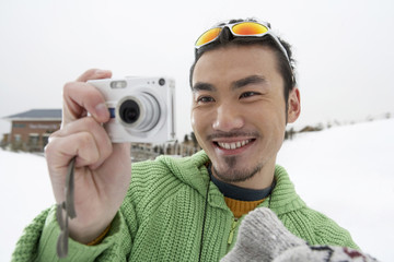Man Taking Photo On Ski Field