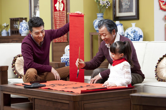 Family With Chinese Calligraphy During Chinese New Year