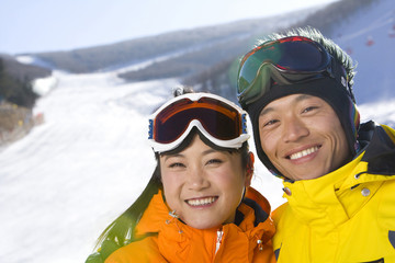 Close-up of a young man and young woman smiling